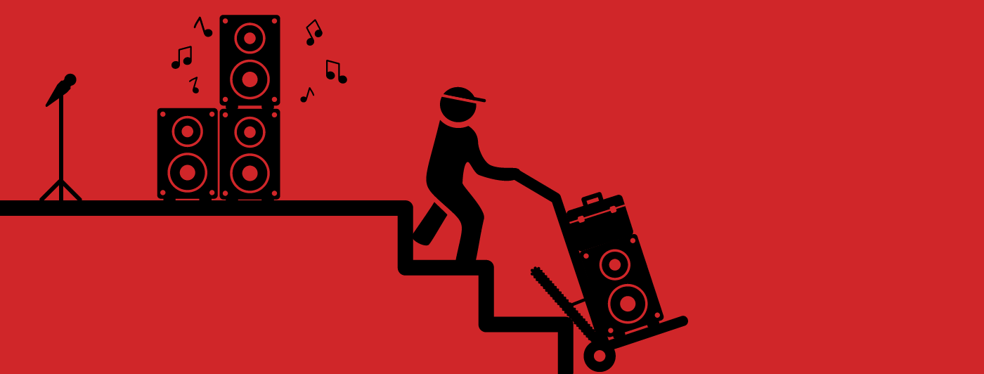 someone using a motorized hand truck to carry heavy speakers up the stairs 